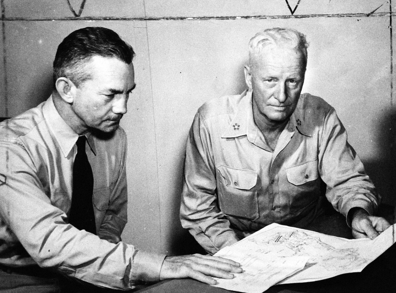 208-PU-70A-6:   Iwo Jima Operations, February 1945.  Secretary of the Navy James V. Forrestal, left, and Fleet Admiral C.W. Nimitz, USN, Commander in Chief, U.S. Pacific Fleet and Pacific Ocean Areas look over final plans for the invasion of Iwo Jima.  The conference occurred at a forward area base shortly prior to the assault on Iwo.   Photograph released February 25, 1945.   Office of War Information Photograph, now in the collections of the National Archives.  (2016/03/29).