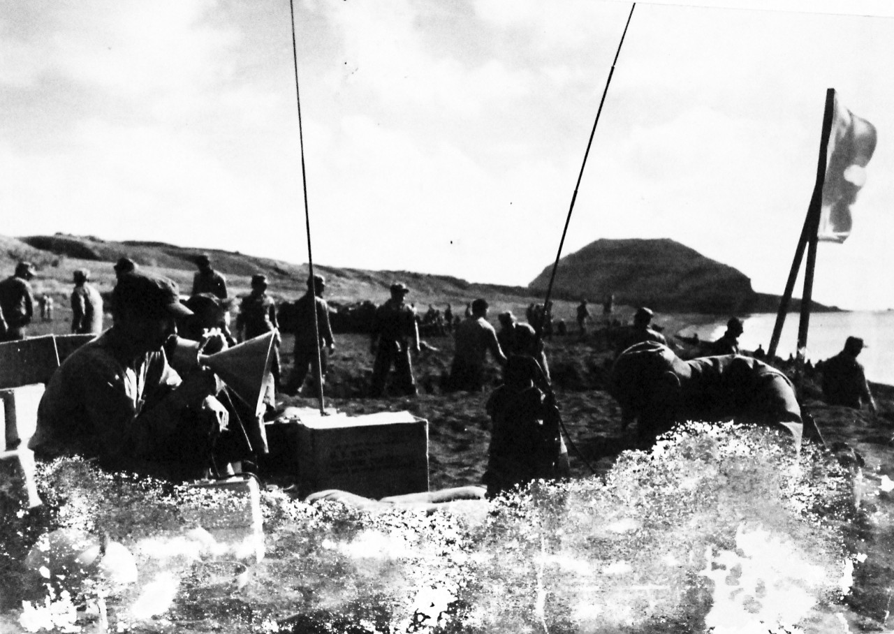 127-GW-316-4178463: Iwo Jima Operations,  February-March 1945. Navy Shore Party: Crew members from USS Menifee (APA-202) direct the unloading of landing boats on the west beach of Iwo Jima Photographed by Sergeant Altfather, February 1945.  Offcial U.S. Marine Corps Photograph, now in the collections of the National Archives.  (2016/09/06).