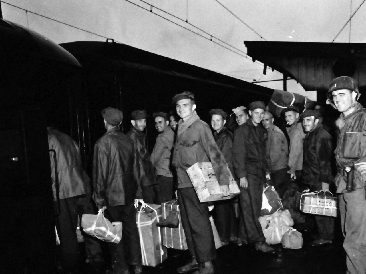 80-G-339424:  Prisoner of War Camp, Ofuna, Yokohama, Japan, 1945.   Liberated American Prisoners of War leave Ofuna prison camp by train bound for Atsugi, September 1, 1945.   Ofuna was located at Kamakura, Japan, just outside of Yokohama.   Photographed by Photographer’s Mate Cates.   Official U.S. Navy photograph, now in the collection of the National Archives.  (2013/08/14).    Note, the original photograph is about 1” x 1” in size.   