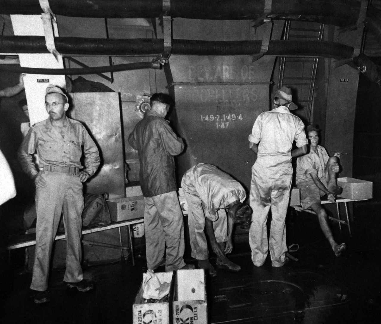 80-G-343554:    Allied Prisoner of War, Formosa, 1945.  Liberated British Officers from a Formosan prison camp try out new clothes on board USS Block Island (CVE 106) after three years confinement.   Photographed by Photographer’s Mate First Class T.K. Brett, September 5, 1945.   Official U.S. Navy photograph, now in the collection of the National Archives.  (5/22/2014).   