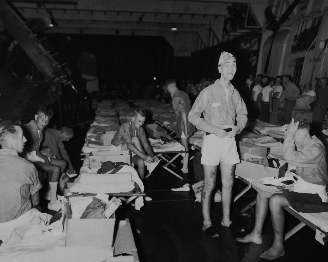 80-G-343560:   Allied Prisoners of War, 1945.   Bombardier Walter G. McFarlane, liberated after 3.5 years captive at Singapore enjoys the comforts provided on the hangar deck of USS Block Island (CVE-106).   Photographed by Photographer’s Mate First Class T.K. Brett, S 1945.  Official U.S. Navy photograph, now in the collection of the National Archives.  (2014/05/22).   The original photograph is small.   