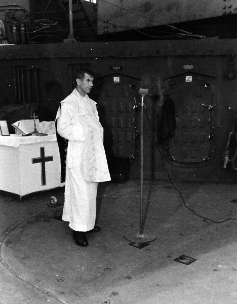 80-G-344563:  Allied Prisoners of War, 1945.    Major Albert W. Braun, U.S. Army Chaplain, holding divine services aboard ship.  Major Braun was captured by the Japanese at Corregidor on May 5, 1942, but the Japanese allowed him to conduct services in bath houses and Philippine natives helped getting altar supplies for him.  Photograph released September 24, 1945.  Official U.S. Navy photograph, now in the collections of the National Archives.   (2015/11/24).