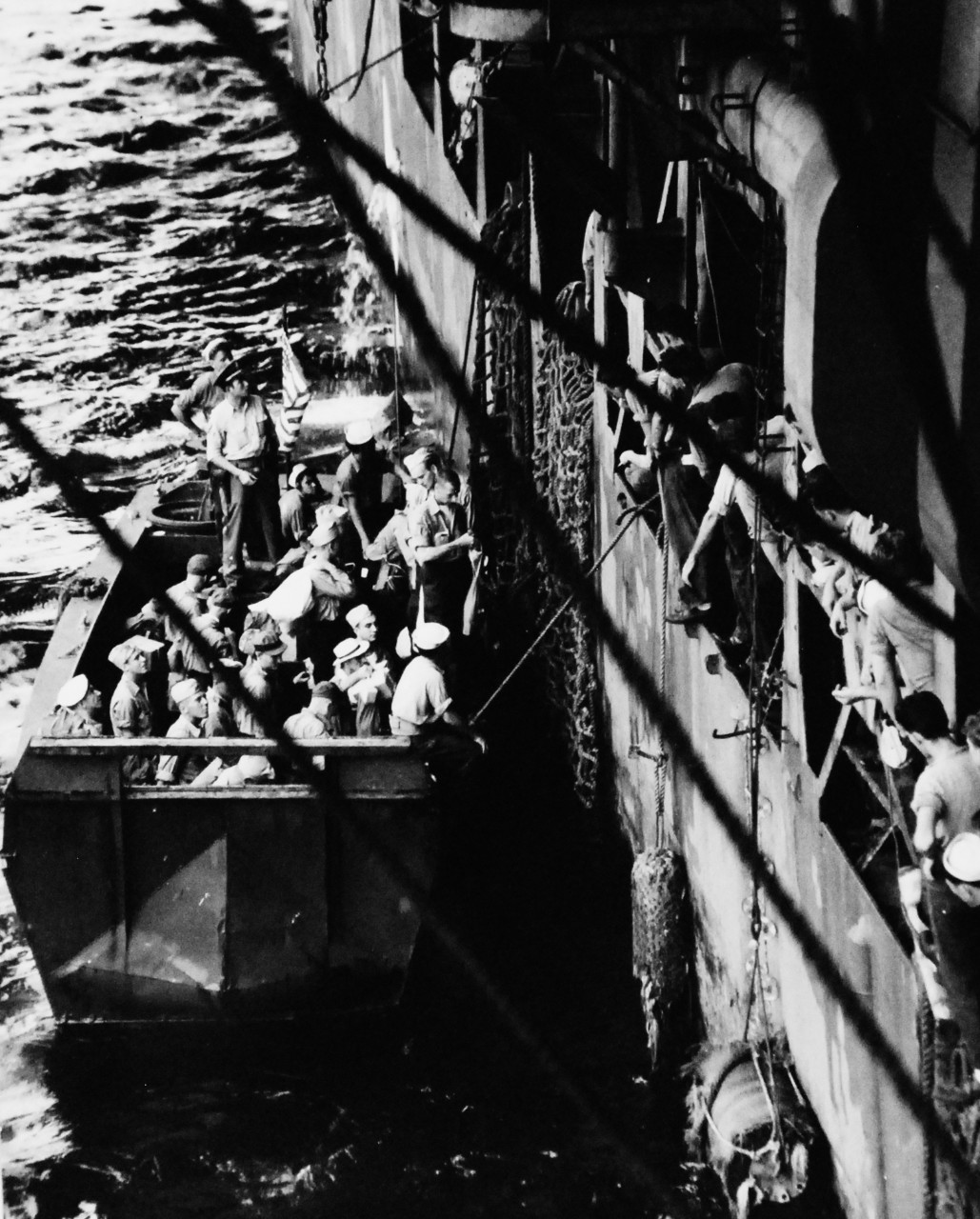 80-G-346551:  Allied Prisoners of War, 1945.    Liberated Prisoners of War camps going on board USS Chenango (CVE-28) at Nagasaki, Japan.  These men await to scramble up the landing nets. Photographed by crew of USS Chenango (CVE-28), September 13, 1945.  Official U.S. Navy photograph, now in the collections of the National Archives.   (2014/11/5).