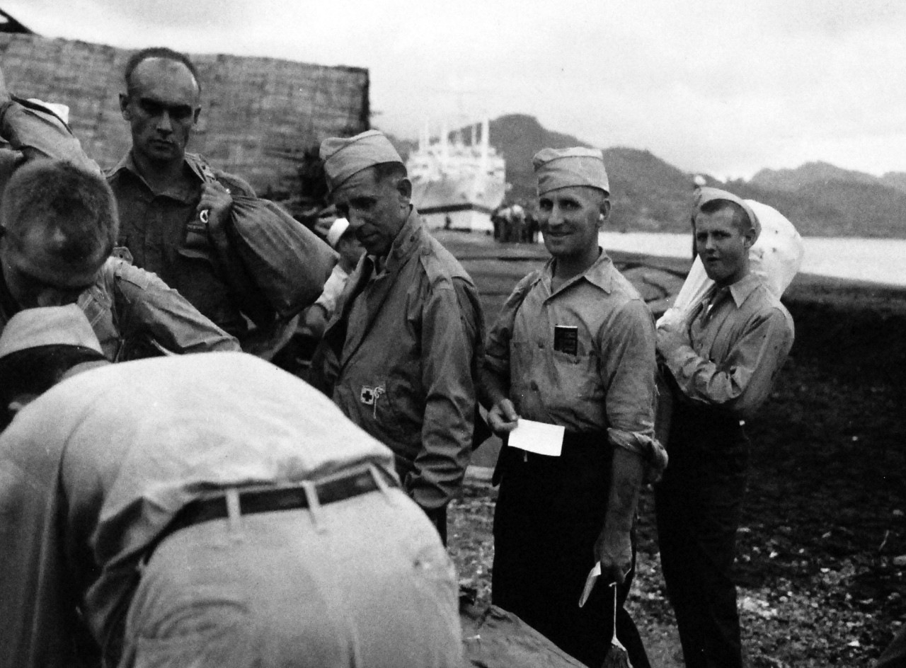 Allied Prisoners of War, 1945.    British Prisoner of War, J. Payne, logs out of Japan and will shortly be loaded into a LCVP that will carry him to USS Chenango (CVE-28).  Photographed by crew of USS Chenango (CVE 28), 13 September 1945.  Official U.S. Navy photograph, now in the collections of the National Archives.   (2014/11/5).