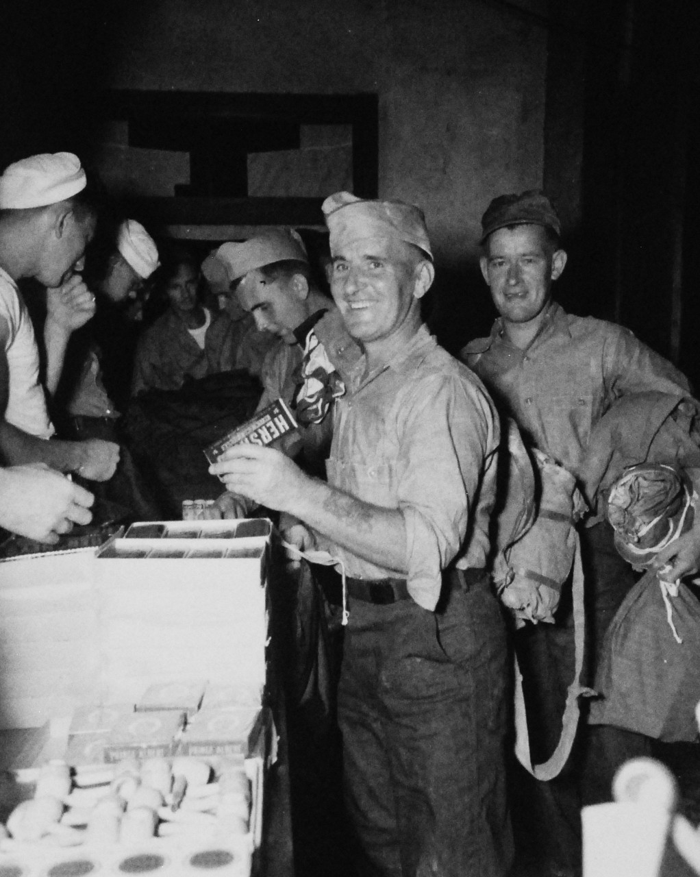 80-G-346581: Allied Prisoners of War, 1945.     J. Payne, who was a British Prisoner of War on Koyagi Island prison camp, is now going through the liberation routine at the Nagasaki Evacuation Center.   He is getting lunch and complete Red Cross Kit.   Photographed by crew of USS Chenango (CVE-28), 13 September 1945.  Official U.S. Navy photograph, now in the collections of the National Archives.   (2014/11/5).