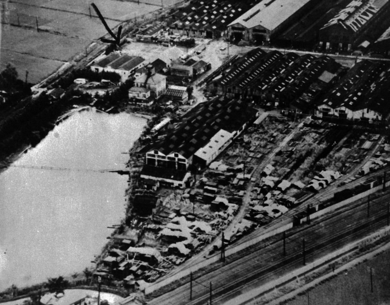 80-G-490389:  Allied Prisoner of War Camp, Tokyo, 1945.  Low aerial of Allied prisoners of war in Tokyo, Japan, area.  Photographed after food was dropped from planes. Note the PW on the rooftops. Released August 29, 1945.   Official U.S. Navy Photograph, now in the collections of the National Archives.   (2015/11/10).