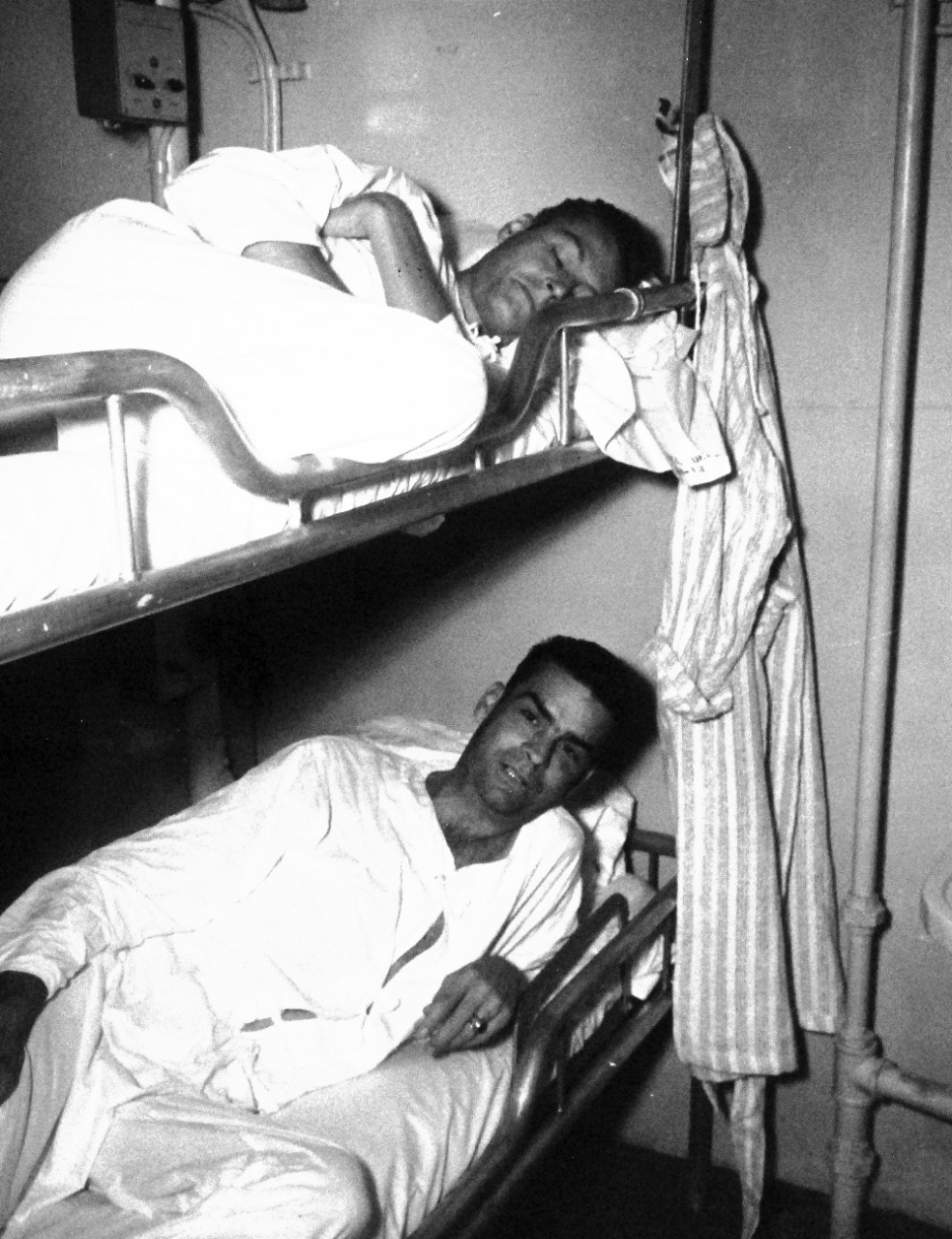 80-G-490454:  Allied. Prisoners of War, 1945.   USS Benevolence (AH-13).   U.S. Army B-29 pilots are rescued from prison camp.  Shown:   Colonel Richard H. Carmichael, upper bunk, and Colonel R.H. King, August 30, 1945.   Official U.S. Navy photograph, now in the collections of the National Archives.  (2014/05/29).    The original is a small photograph.   