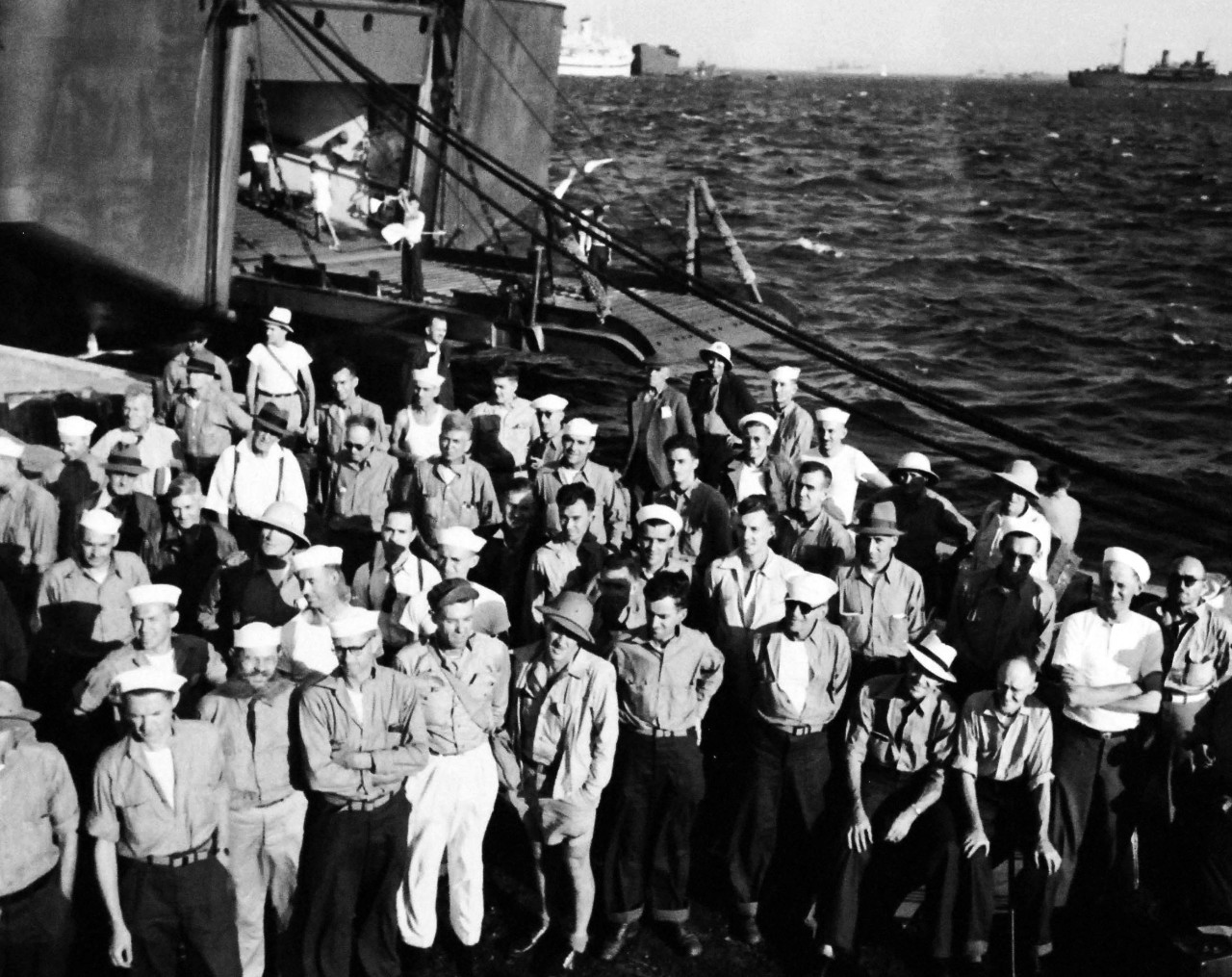 80-G-495640:   Prisoner of War Camp, Japan, 1945.    Former Prisoners of War preparing to leave Yokosuka, Japan, for the United States.   The prisoners of war line up at the dock.   Photograph released September 19, 1945.  Official U.S. Navy photograph, now in the collections of the National Archives.  (2014/05/29).    The original is a small photograph.   