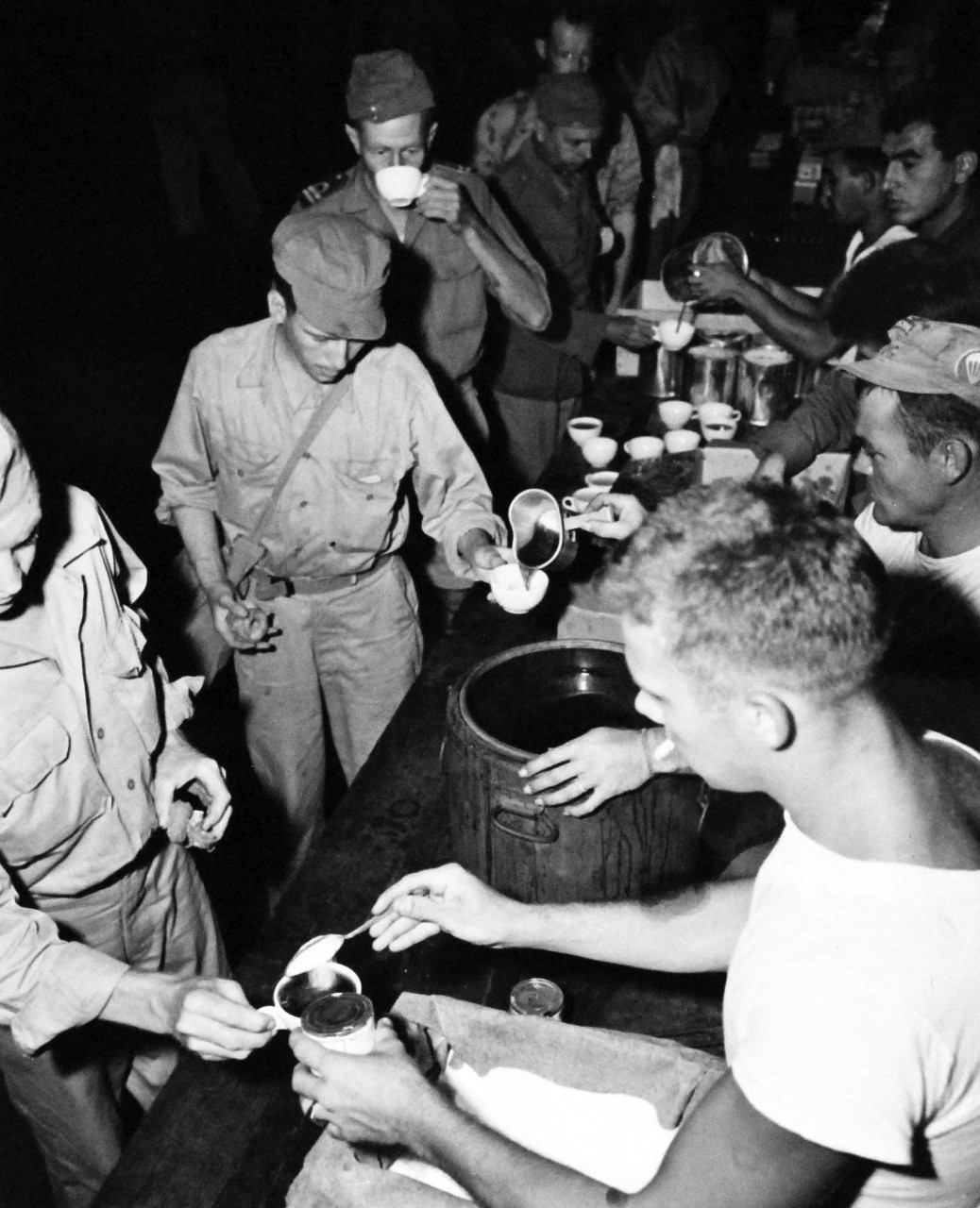 80-G-495643:  Prisoner of War Camp, Japan, 1945.    Former Prisoners of War preparing to leave Yokosuka, Japan, for the United States.  Coffee and doughnuts are served.  Some of these are Allied prisoners.  Photograph released September 19, 1945.  Official U.S. Navy photograph, now in the collections of the National Archives.  (2014/05/29).    The original is a small photograph.   
