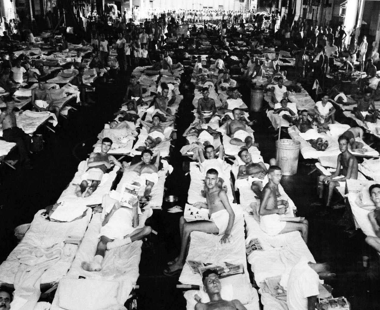 80-G-495664:   Allied Prisoners of War, Formosa, 1945.   Brought to liberty from under Japanese maltreatment on Formosa, before occupation forces appeared to take over the island.  These 474 British and American soldiers rest, eat and sleep on the hangar deck of USS Block Island (CVE-106).  Photograph released September 27, 1945.  Official U.S. Navy photograph, now in the collections of the National Archives.  (2014/05/29).    The original is a small photograph.   