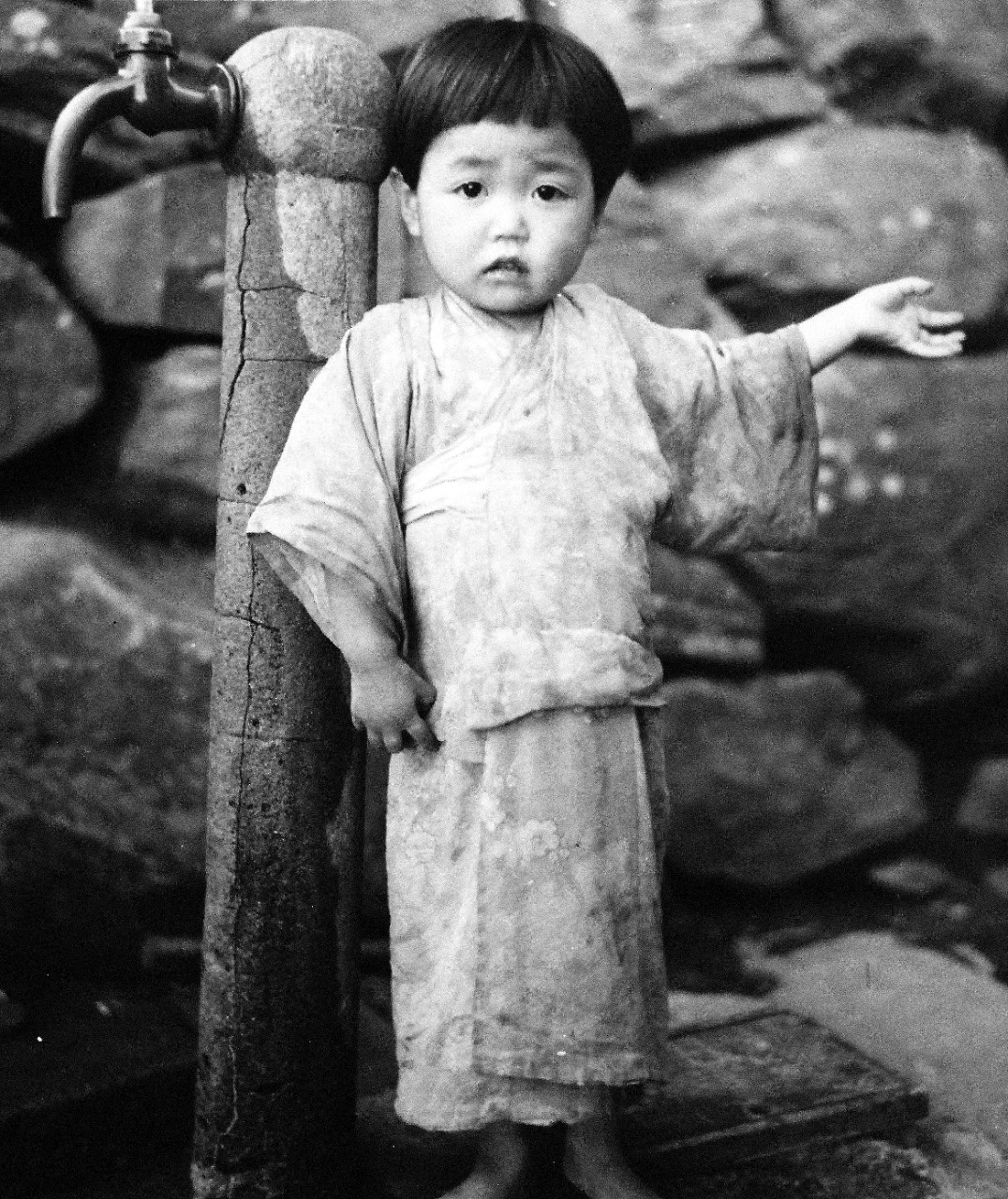 80-G-264847:   Occupation of Japan, 1945.    Scene at Sasebo, Kyushu, Japan, shows Japanese child.  Photographed by crewmember of USS Chenango (CVE-28), released October 19, 1945.   Official U.S. Navy photograph, now in the collection of the National Archives.  (2015/12/01).