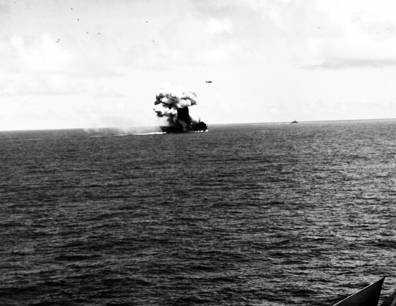 80-G-270618:  Battle off Samar, Japanese Kamikaze, October 25, 1944.    Fires and explosion on the flight deck of USS Suwannee (CVL-27), resulting from a suicide hit of a Japanese “Zero” near Leyte, Philippines.   The airborne plane is friendly.   Taken from USS Sangamon (CVL-26) at Leyte, Philippines.  Official U.S. Navy Photograph, now in the collections of the National Archives.  (2014/4/24). 