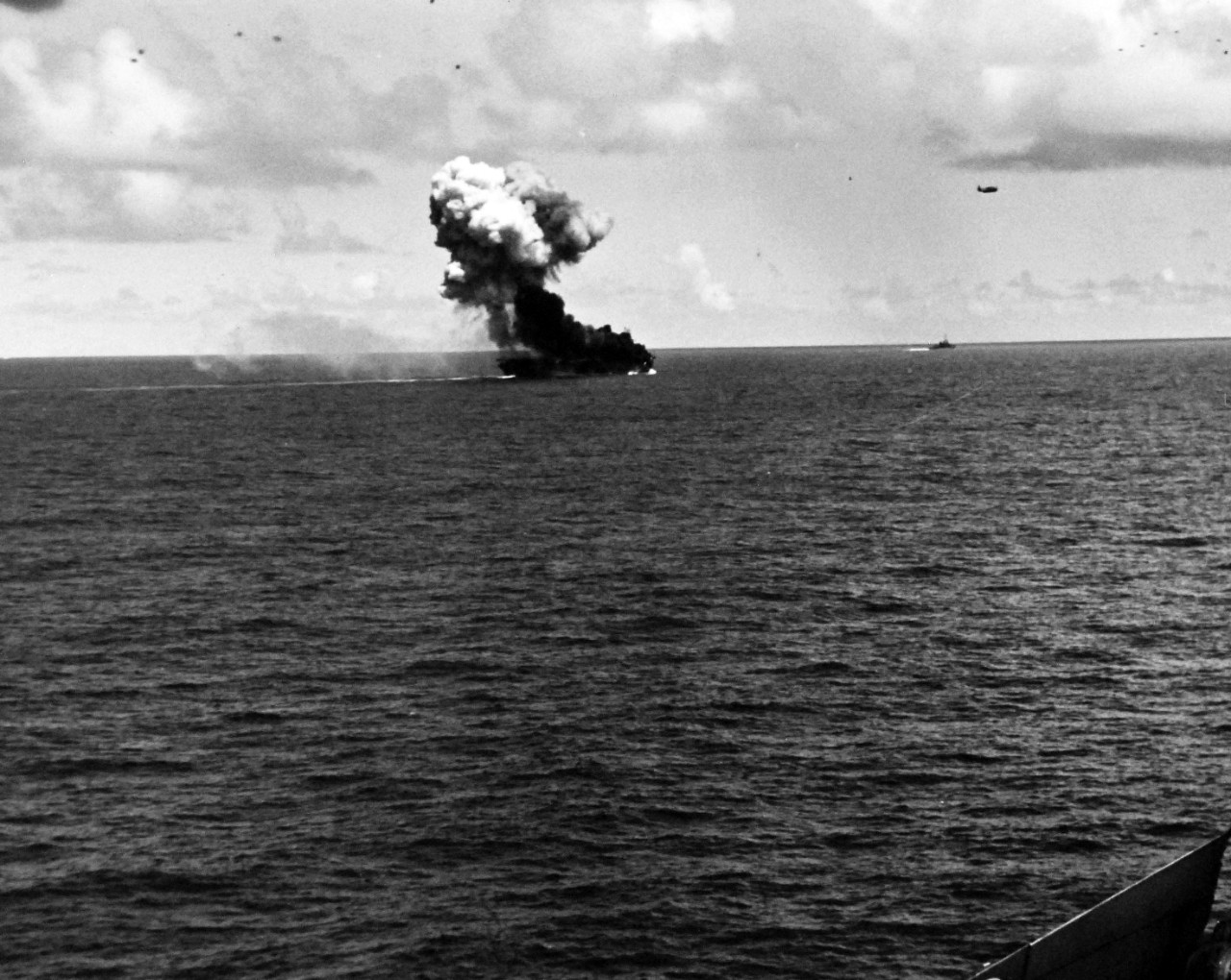 80-G-270619:  Battle off Samar, Japanese Kamikaze, October 25, 1944.    Fires and explosion on the flight deck of USS Suwannee (CVL 27), resulting from a suicide hit of a Japanese “Zero” near Leyte, Philippines.   The airborne plane is friendly.   Taken from USS Sangamon (CVL 26) at Leyte, Philippines, 26 October 1944.   Official U.S. Navy Photograph, now in the collections of the National Archives.  (2014/4/24). 