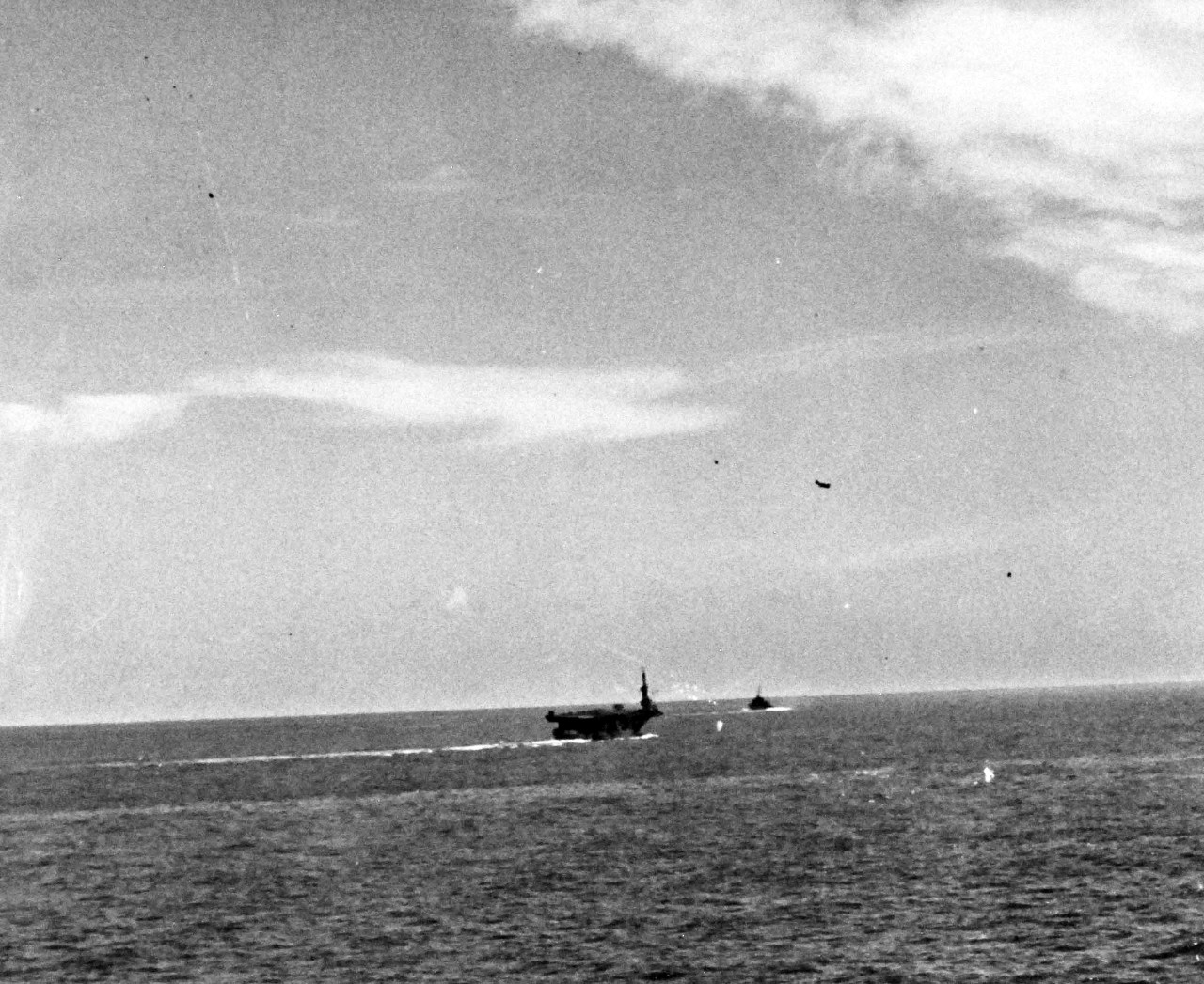 80-G-270668:    Battle off Samar, Japanese Kamikaze, October 25, 1944.    A near miss by a Japanese “Zero” on USS Petrof Bay (CVE-80) off Leyte Gulf, as seen from USS Suwannee (CVE-27).  Bomb is hitting the water.   Petrof Bay served with Task Group 77.4.1 “Taffy 1” during the battle.    Official U.S. Navy Photograph, now in the collections of the National Archives.   (2014/4/24). 