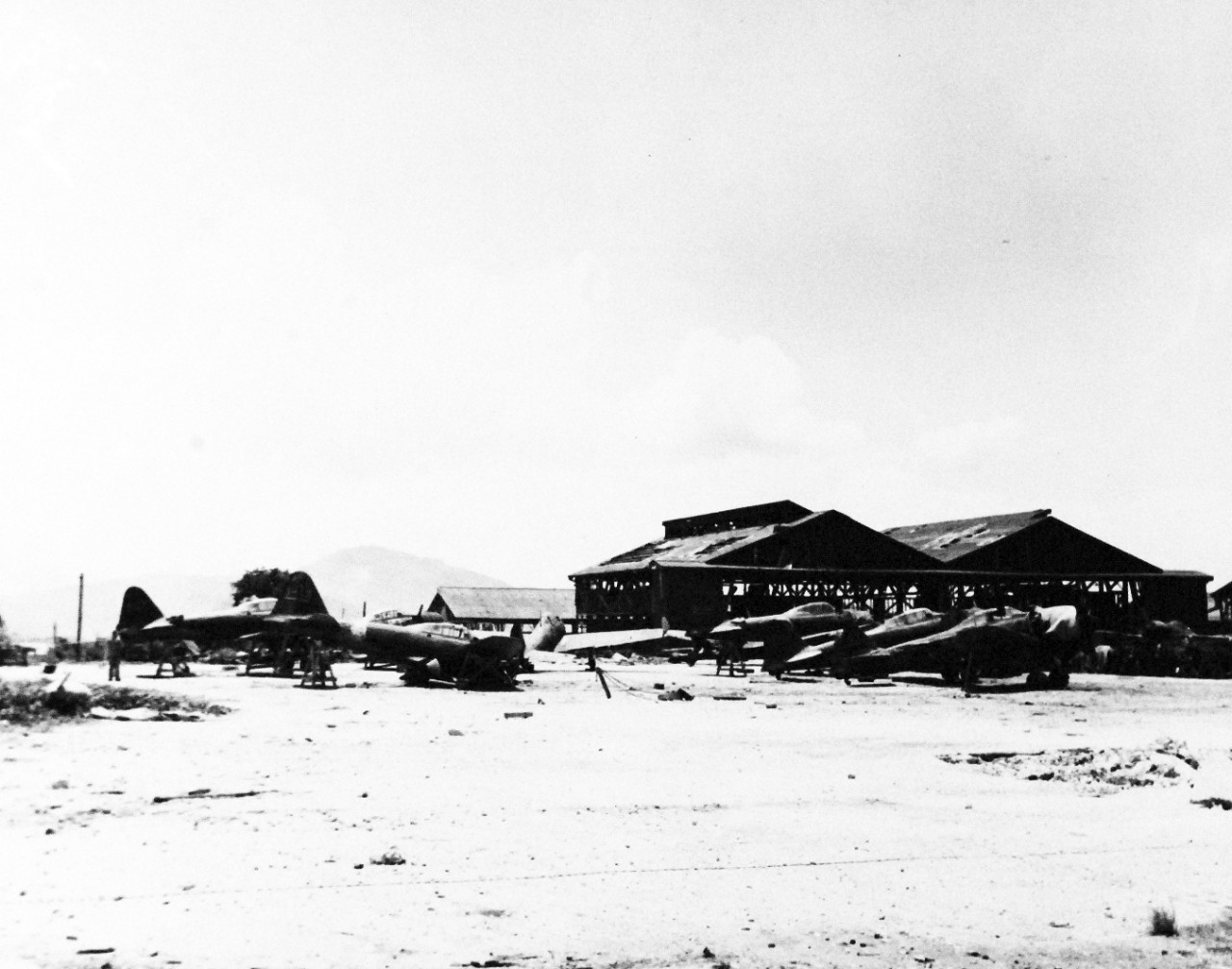 80-G-287136:   Invasion of Saipan, June-July 1944.     Japanese aircraft on Aslito airfield, Saipan, destroyed on the ground by U.S. Aerial bombing, Japanese Zero’s and hangars, July 8, 1944.   Official U.S. Navy photograph, now in the collections of the National Archives.  (2017/03/21).  