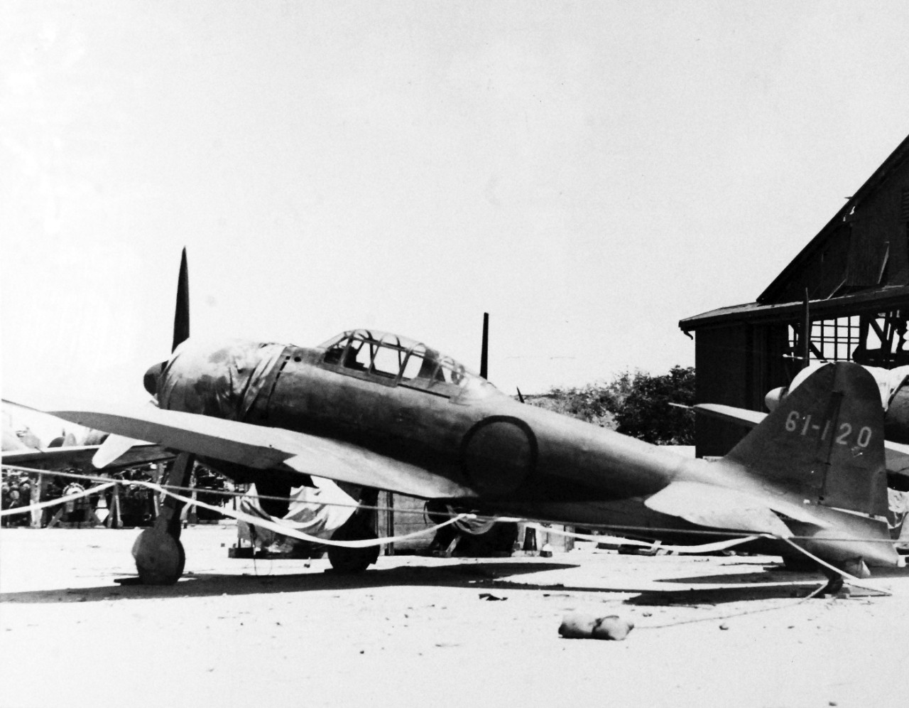 80-G-287159:   Invasion of Saipan, June-July 1944.   Japanese Mitsubishi A6M "Zero" aircraft on Aslito airfield, Saipan, destroyed on the ground by U.S. Aerial bombing, Japanese Zero’s and hangars, July 8, 1944.     Photographed by USS Indianapolis (CA 35) photographer.   Official U.S. Navy photograph, now in the collections of the National Archives.  (2017/03/21).  