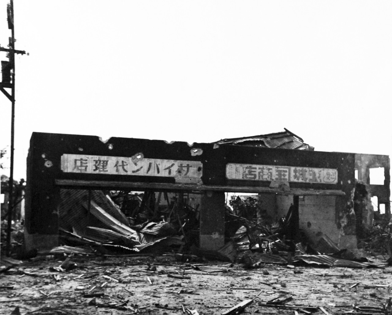 80-G-287177:   Invasion of Saipan, June-July 1944.   General destruction ahead of Marine front lines on Saipan showing a building ruined,  July 2, 1944.     Photographed by USS Indianapolis (CA-35) photographer.   Official U.S. Navy photograph, now in the collections of the National Archives.  (2017/03/21).  