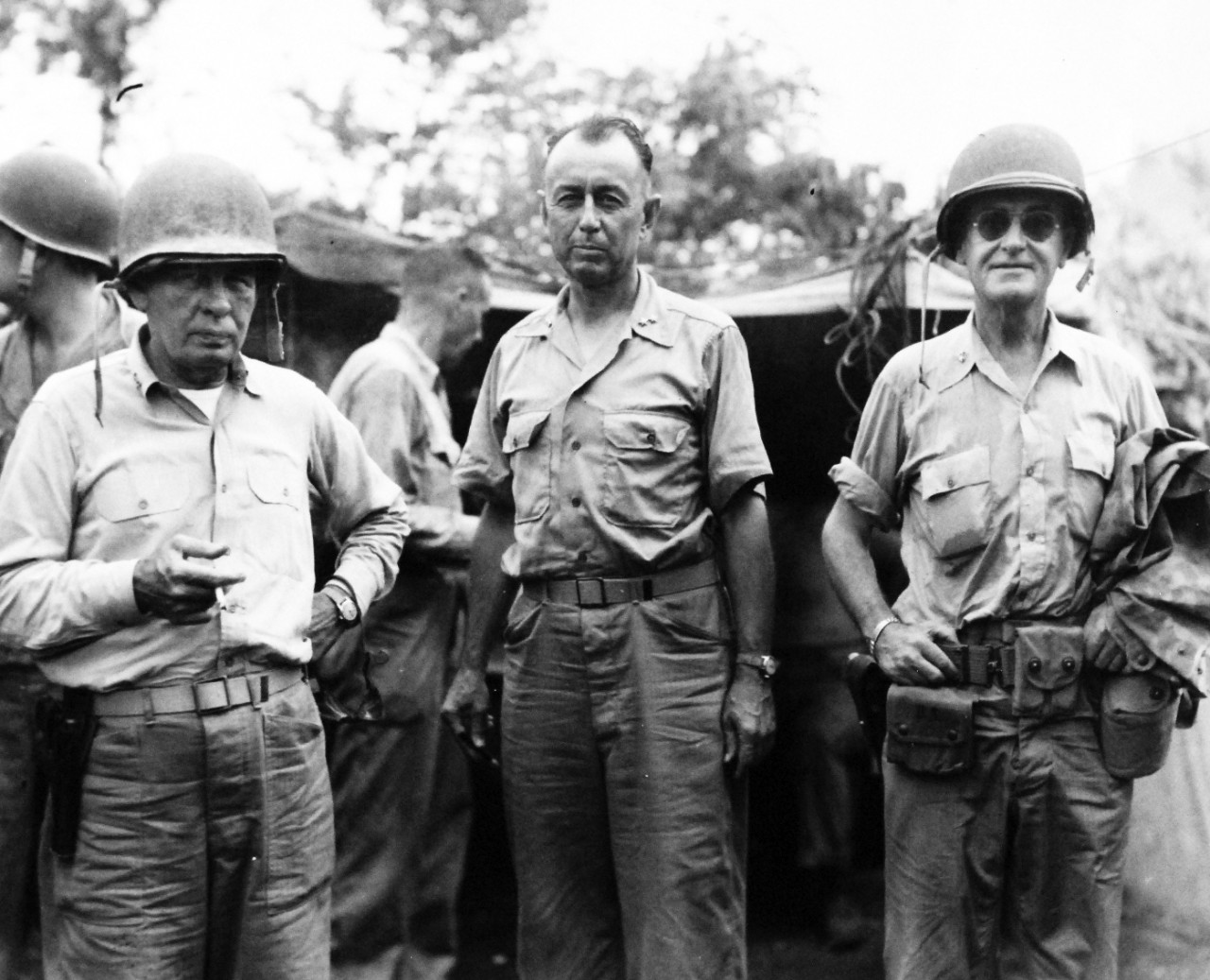 80-G-239319:  Invasion of Tinian, July-August 1944.   Two U.S. Marine Generals confer with Rear Admiral W. Chambers, (right), USN, Inspector Medical Department Activities, Pacific Area, on Tinian, where the Admiral was inspecting medical facilities.  The Marine officers are Major Generals Harry Schmidt (left) and Clifton B. Cates, released August 5, 1944.    Official U.S. Navy photograph, now in the collections of the National Archives.  (2017/03/07).