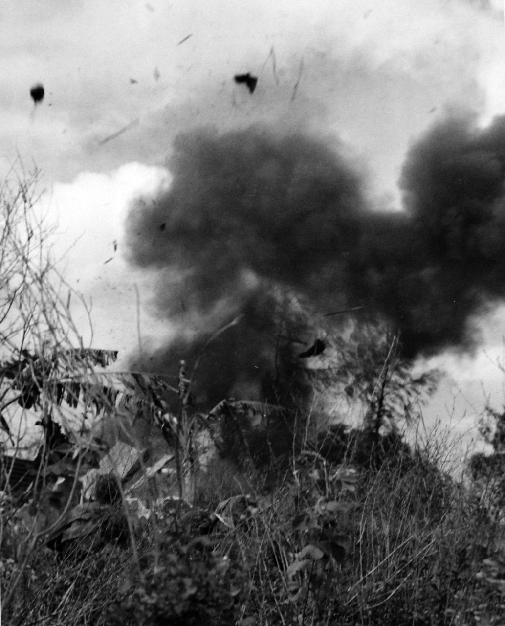 80-G-239320:   Invasion of Tinian, July-August 1944.    U.S. Marines set off a dynamite charge blowing a Japanese dugout to pieces on Tinian.  Sailing high into the air, is the helmet (left) of a soldier who refused to surrender, although the island fell to the Second and Fourth Marine Divisions days before, released August 5, 1944.    Official U.S. Navy photograph, now in the collections of the National Archives.  (2017/03/07).