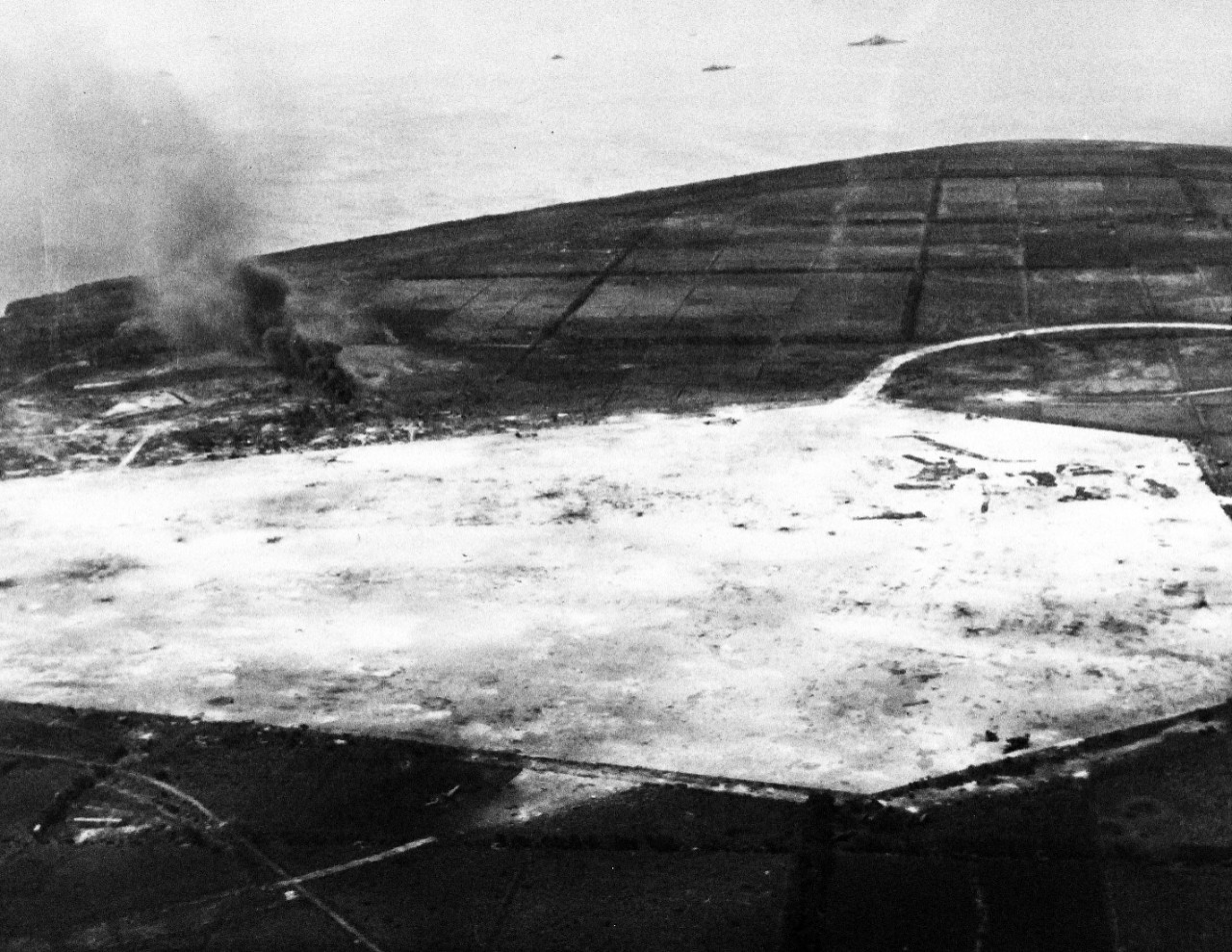 80-G-384173:   Invasion of Tinian, July-August 1944.   Bombing of Tinian Island on D-Day, taken by plane from USS White Plains (CVE-66), July 24, 1944.  Official U.S. Navy Photograph, now in the collections of the National Archives.   (2015/3/4). 