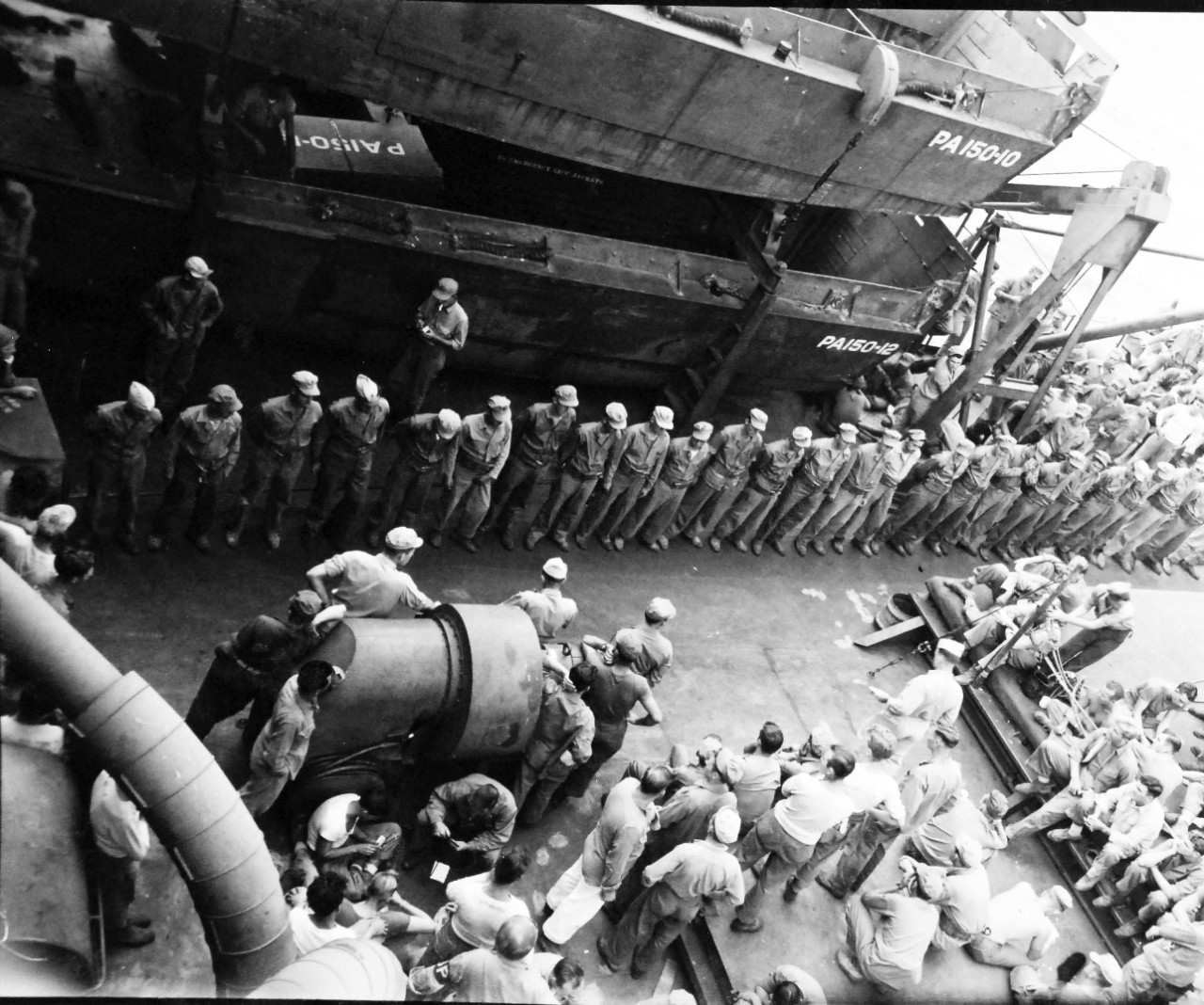 127-GW-224-225168:  Okinawa Campaign, Purple-Hearts, September 30, 1945.   USS Bergen (APA-150).   Purple Hearts being awarded to Marines of Engineer Company, Second Battalion (d1).  Total of 25 men received for wounds on Okinawa.   Awards were given en-route to China.   Photographed by Huntington, September 30, 1945.  Official U.S. Marine Corps Photograph, now in the collection of the National Archives.  (2015/5/5). 