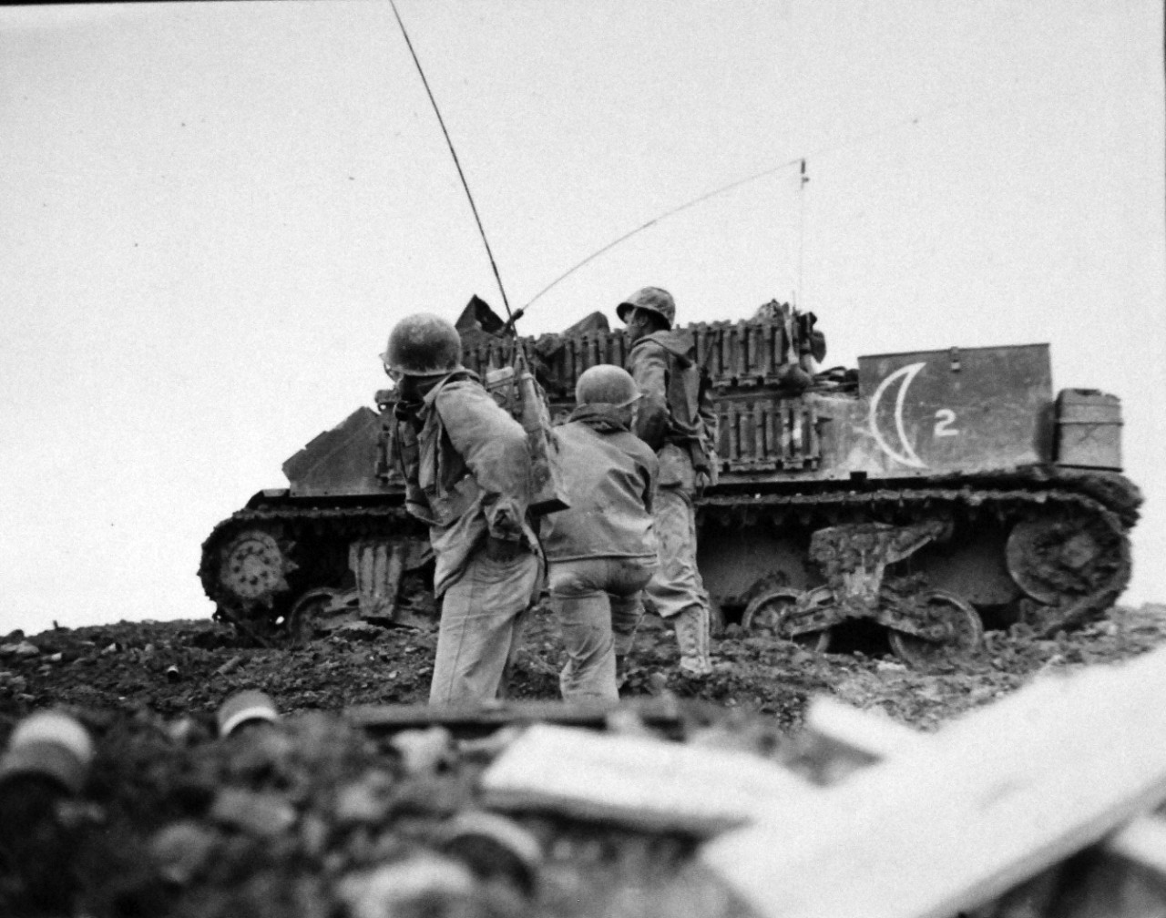 127-GW-518-122036:  Okinawa Campaign, April-June 1945.    Radioman and observer direct fire of M-7 in rear at Okinawa.  Photographed by Corporal Yakimovich, 24 May 1945.  Official U.S. Navy Photograph, now in the collections of the National Archives.   (2014/6/25). 
