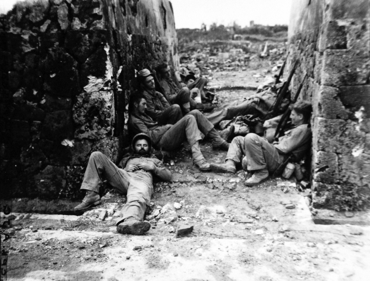 127-GW-518-122511:   Okinawa Campaign, April-June 1945.     Marines of the 60 Mortars George Company, 22nd Marines, Second Battalion, rest after hard night fighting.  This was taken in Naha, Okinawa.   Photographed by Giossi, May 29, 1945. Official U.S. Navy Photograph, now in the collections of the National Archives.   (2014/6/25). 