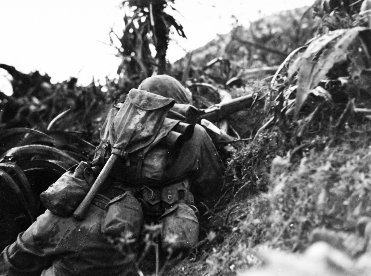 127-GW-518-122603:  Okinawa Campaign, April-June 1945.     U.S. Marine firing from cover of brush, Okinawa.   Photographed by Yakimovich, 4 June 1945.  Official U.S. Navy Photograph, now in the collections of the National Archives.   (2014/6/25).
