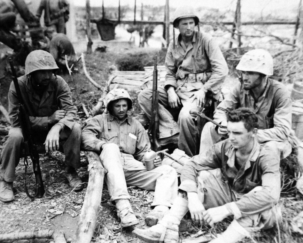 127-GW-518-122835:   Okinawa Campaign, April-June 1945.     A group of tired Marines of 22nd Regiment shortly after they were relieved.  They had up to this time spent 62 days on Okinawa, 25 of which were on the Southern front.   Photographed by MacIntosh, 2 June 1945.  Official U.S. Navy Photograph, now in the collections of the National Archives.   (2014/6/25). 