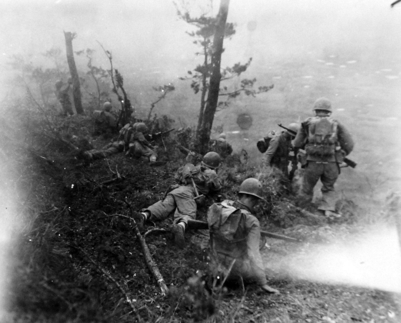 127-GW-518-122843:  Okinawa Campaign, April-June 1945.     U.S. Marines get the word to go down the side of the hill, here under supporting light machine gun fire.  They then charge down the side of the hill at the Japanese, Okinawa.   Photographed by Henderson, 1 June 1945.  Official U.S. Navy Photograph, now in the collections of the National Archives.   (2014/6/25).