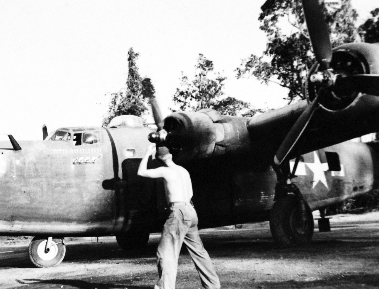 127-GW-520-80900:   Okinawa Campaign, April-June 1945.     All clear on Engine Two, and the flight will soon be ready to get under way.  The photo plane is a converted heavy bomber from which the bomb racks have been removed and the aerial cameras installed, PB4Y.   The silhouette of an aerial camera is painted on the nose of the plane for each mission, Okinawa.     Photographed by Chester L. Smith, April 1944.   Official U.S. Navy Photograph, now in the collections of the National Archives.   (2014/6/25).