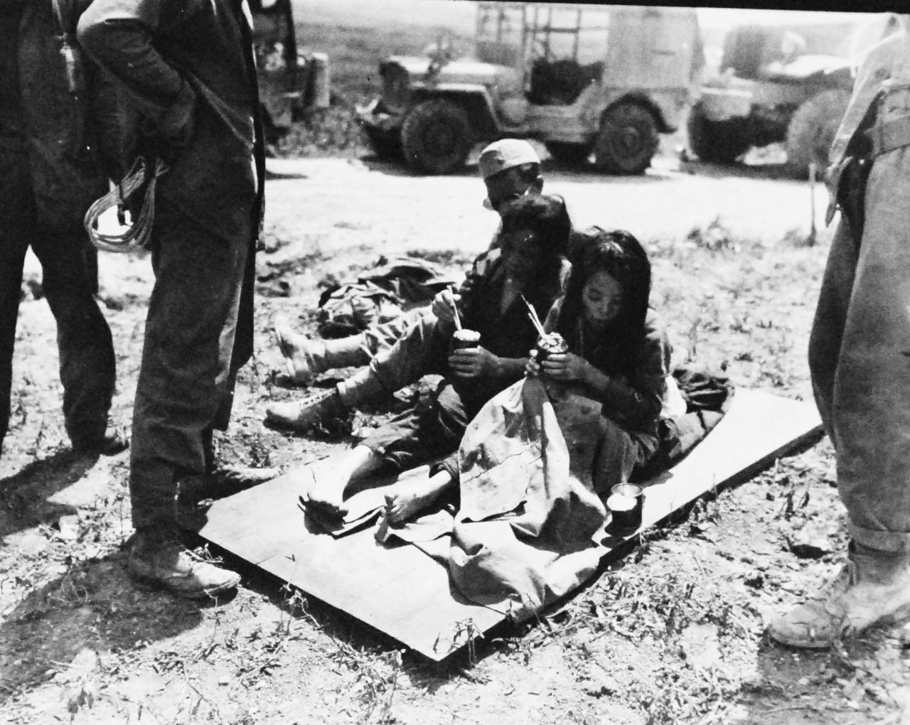 127-GW-666-128250:  Okinawa Campaign, April-June 1945.  Marines watching native Okinawan women eat rations after being held by the Japanese as prisoners.  Photographed by John Smith, June 1945.  Official U.S. Marine Photograph, now in the collection of the National Archives.  (2014/7/23). 