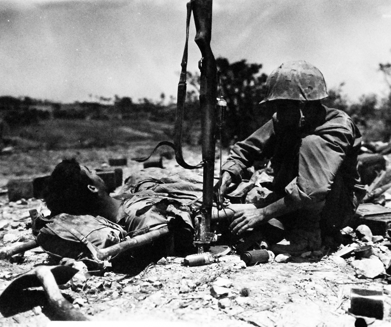 127-GW-667-120199:  Okinawa Campaign, April-June 1945.   Plasma given to a wounded Marine on Okinawa.  Photographed by Bushemi, May 1945.  Official U.S. Marine Photograph, now in the collection of the National Archives.  (2014/7/23). 