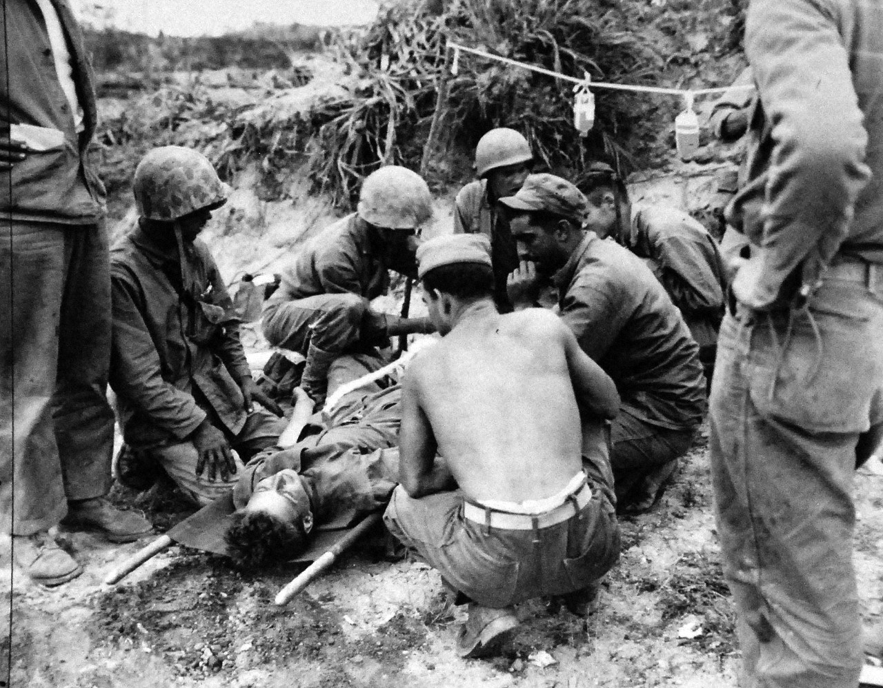 127-GW-667-120316:  Okinawa Campaign, April-June 1945.   U.S. Navy Corpsmen giving blood plasma.  This picture was made while under snipe and mortar fire.  Two Corpsmen were killed five minutes after this picture was made.   Photographed by Corporal MacIntosh, 1945. Official U.S. Marine Photograph, now in the collection of the National Archives.  (2014/7/23). 