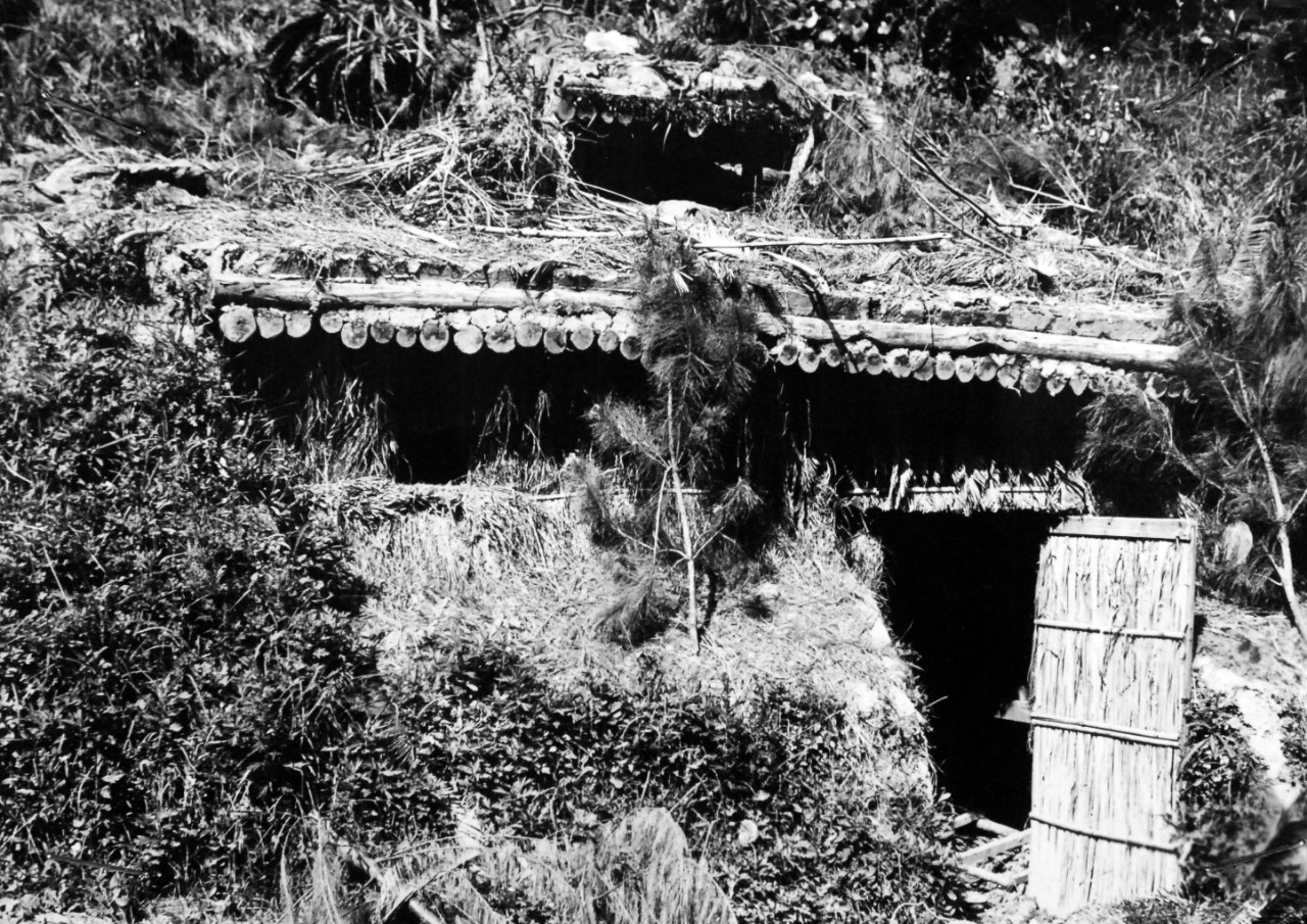 208-MO-Box-113-Okinawa-1:  Okinawa Campaign, April-June 1945.   Former Japanese Dugout on Okinawa Now In American Hands.  This dugout was used as a living quarters by high-ranking Japanese officers before U.S. Tenth Army forces engulfed this area of Okinawa, main Ryukyu island 375 miles from Japan.  The Americans landed on Okinawa in April 1945.  By June 10, the Japanese were compressed into an area of about 16 square miles at the southern tip of the island, and were fighting fiercely to hold the last high ground still in their hands.  Official U.S. Army Photograph, now in the collections of the Office of War Information located at the National Archives.   (2018/05/09).