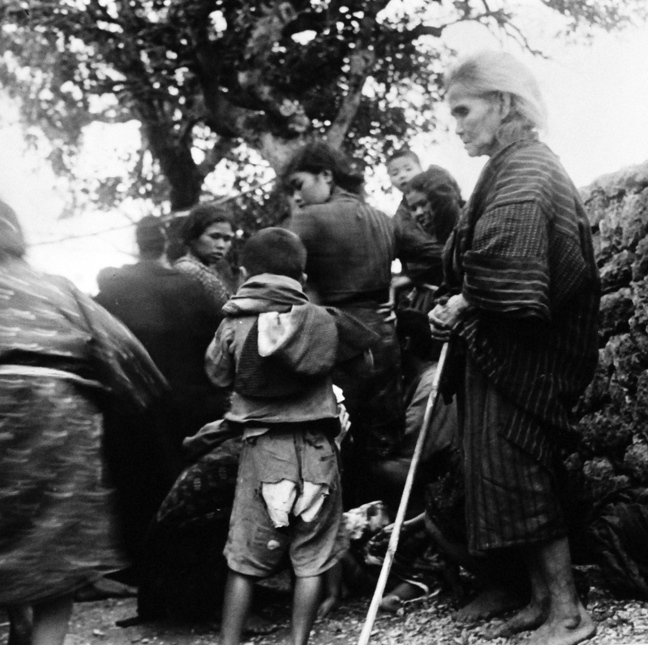 80-G-317106:   Okinawa Campain, April-June 1945.  Natives of Okinawa at internment camp at Sobe, Okinawa.     Photograph by Lieutenant Junior Grade A.B. Rickerby, released April 4, 1945.    Official U.S. Navy Photograph, now in the collections of the National Archives.  (2017/03/07).