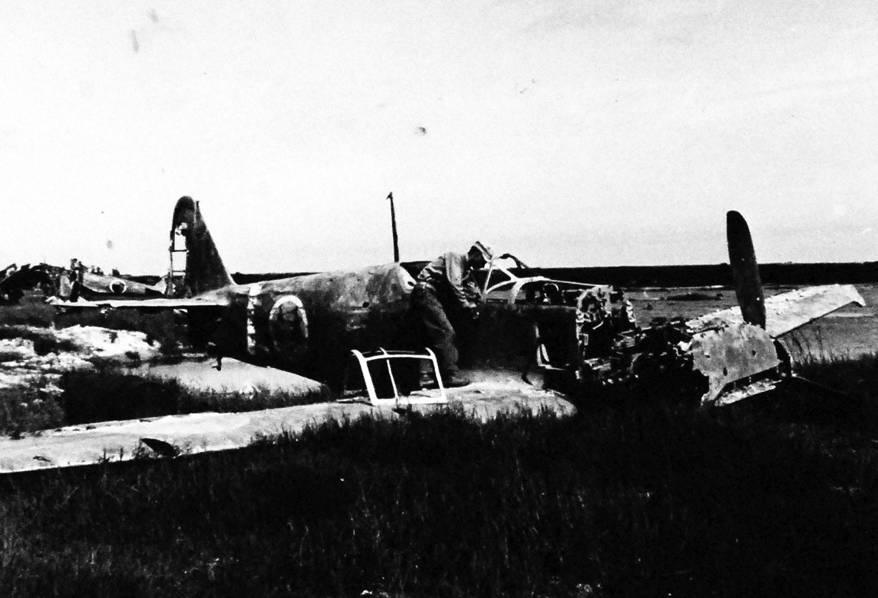 80-G-325330:  Okinawa Campaign, April-June 1945.     Group of smashed Japanese aircraft in the revetments of the airstrip at Naha, Okinawa, Ryukyu Islands.  This specific aircraft is a Kawasaki K-61, nicknamed “Tony”.     Photograph received 6 July 1945.  Official U.S. Navy Photograph, now in the collections of the National Archives.   (2014/5/1). 