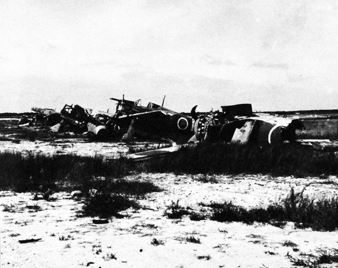 80-G-325331: Okinawa Campaign, April-June 1945.    Group of smashed Japanese aircraft in the revetments of the airstrip at Naha, Okinawa, Ryukyu Islands.  This specific aircraft is a Kawasaki K-61, nicknamed “Tony”.     Photograph received 6 July 1945.  Official U.S. Navy Photograph, now in the collections of the National Archives.   (2014/5/1). 