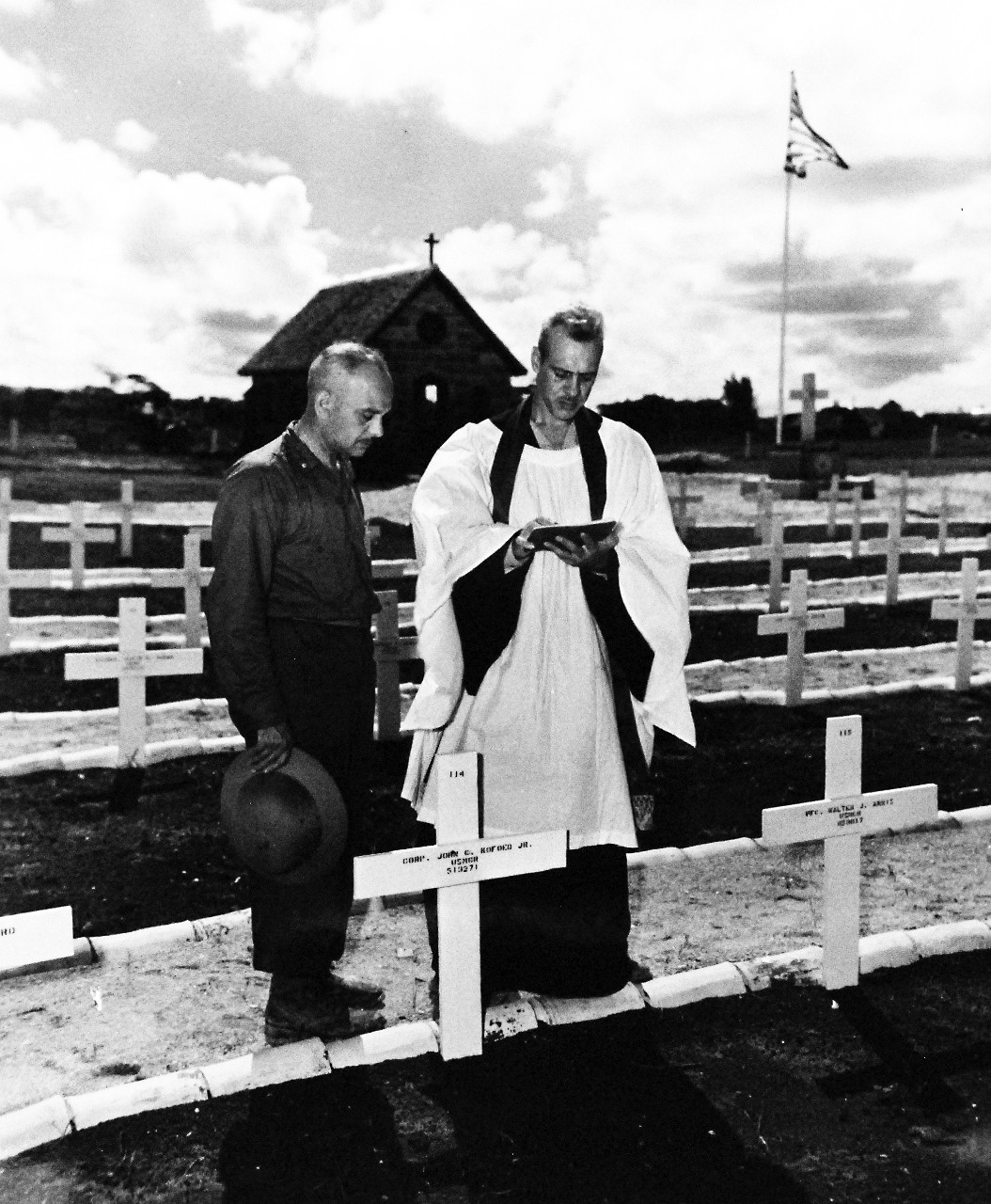 80-G-347084: Okinawa,  Ryukyus Islands, Chaplains, October 1945.   Chaplains Lieutenant Commander O.G. Crotefend (with robe on) shown with Chaplain Matthew V. Crosson at the 6th Marine cemetery at Okinawa Ryukyu Islands.    Photograph received October 5, 1945.    Official U.S. Navy photograph, now in the collections of the National Archives.  (2017/02/14).  