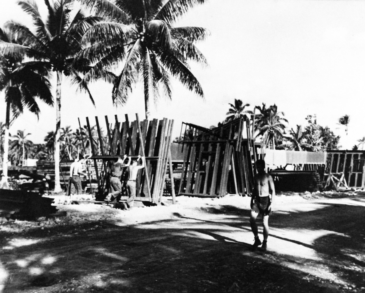 80-G-49583:  Okinawa Campaign, April-June 1945.  Part of assembly line on Okinawa where prefabricated roof and wall sections are bolted before hauling to building sites during construction operations.   Photograph received June 29, 1945.   Official U.S. Navy photograph, now in the collections of the National Archives.  (2017/01/10).