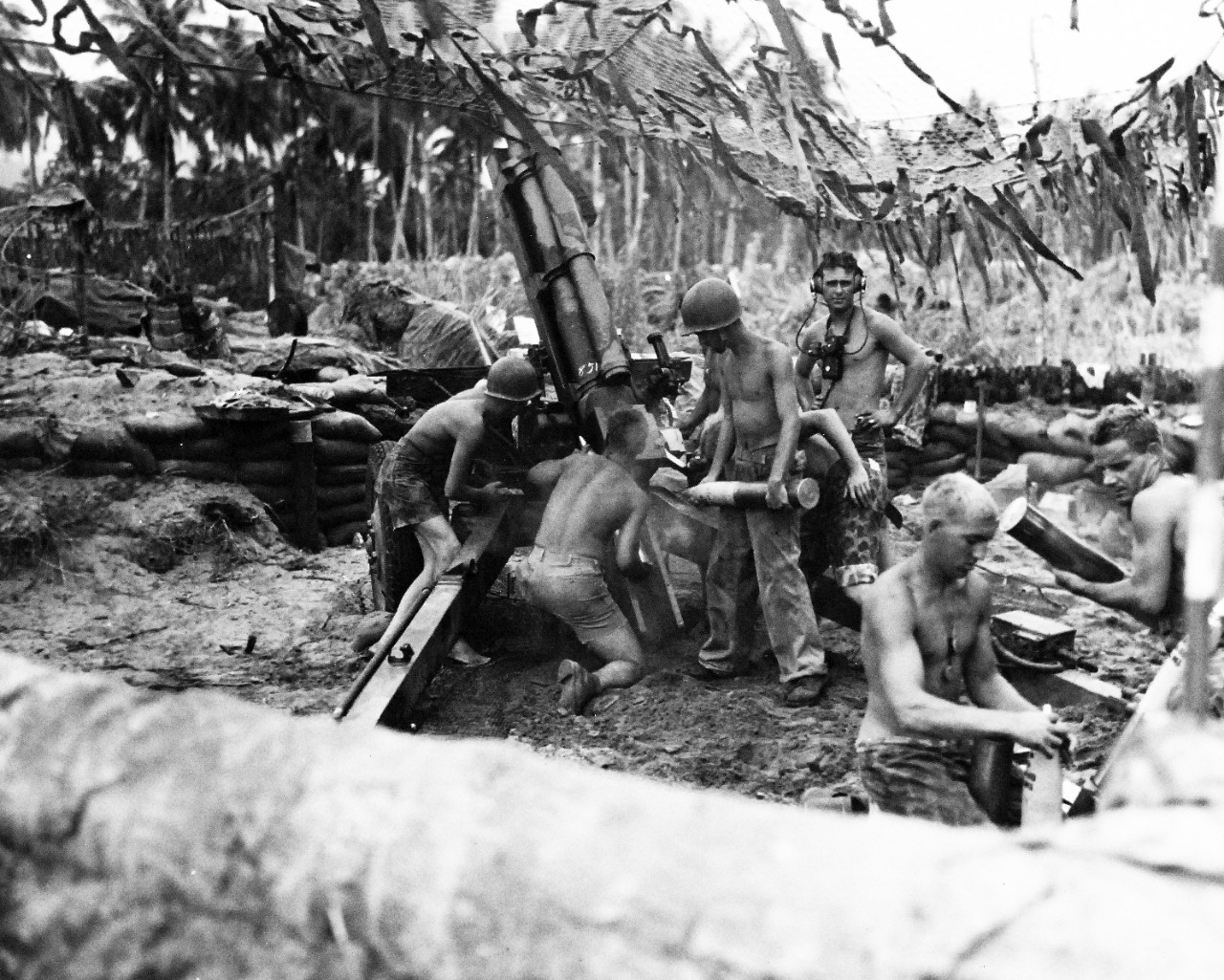 80-G-205283:  Bougainville Campaign, November 1943-August 1945.A U.S. Marine 105mm howitzer gun crew blasts the Japanese enemy paving the way for an infantry advance at Bougainville.  Members of the crew are left to right:  Corporal Marshall E. Farr; Private First Class Finis O. Triplett; Private First Class Donald R. Stewart; Sergeant Woodroe W. Bodine; Private First Class Glenn E. Will and Private First Class Wayne E. Rockwell.  Photograph released December 29, 1943.   Official U.S. Navy Photograph, now in the collections of the National Archives.    (2015/7/14).