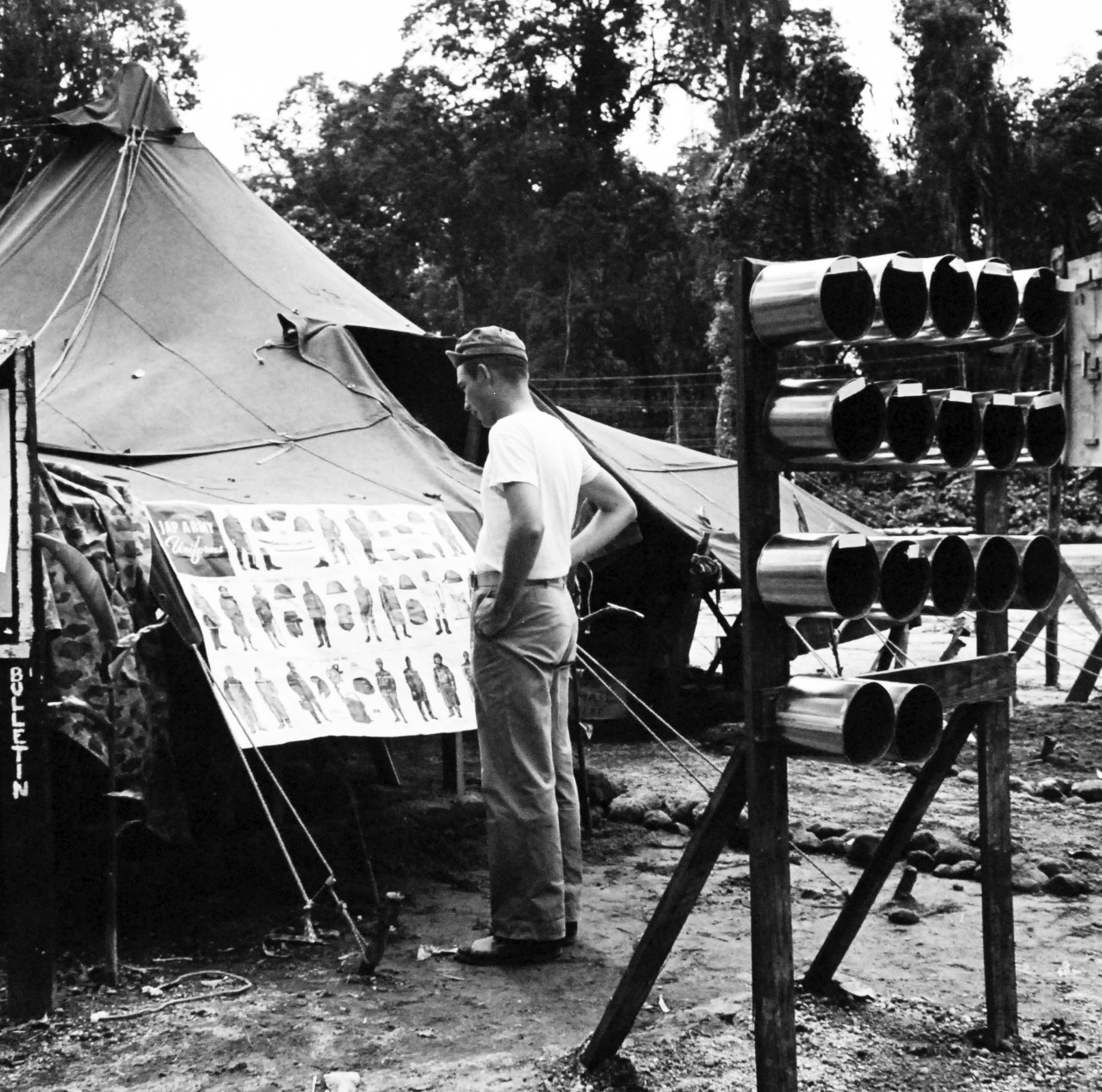 Bougainville Campaign, November 1943-August 1945.   A U.S. Marine studies the latest Japanese military fashion at Headquarters Tent on Bougainville.  The mail boxes were converted from rimmed out tin cans.  Steichen Photograph crew, TR-9566, February 1944.   Official U.S Navy Photograph, now in the collections of the National Archives.  (2017/12/13).