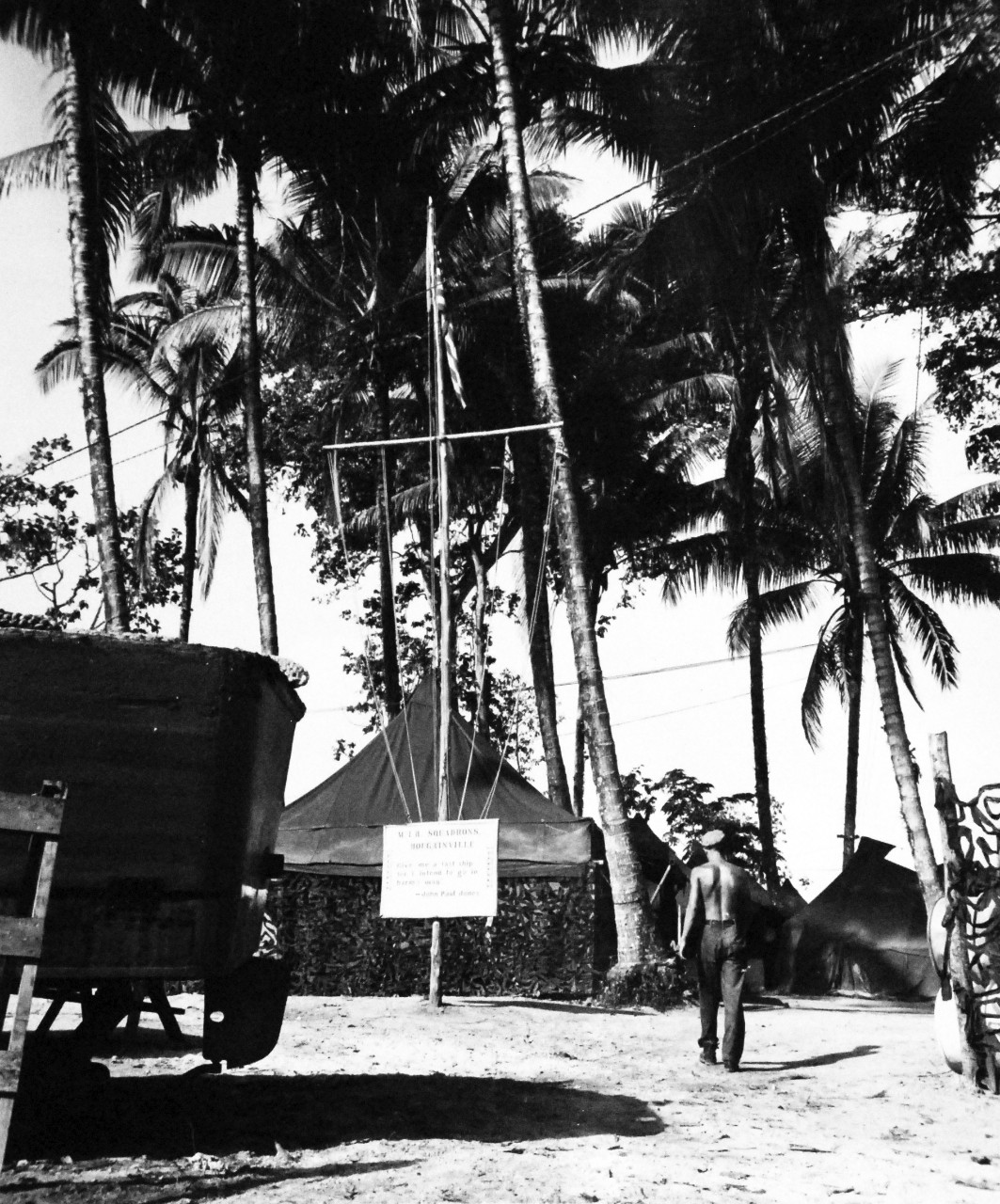 80-G-59331:   Bougainville Campaign, November 1943-August 1945.   U.S. Navy Motor Torpedo Base, Bougainville, Solomon Islands, 10 March 1944.  Entrance to the base.  Note, the squadrons scoreboard with motto in foreground.    Official U.S. Navy Photograph, now in the collections of the National Archives.   (2014/3/12). 