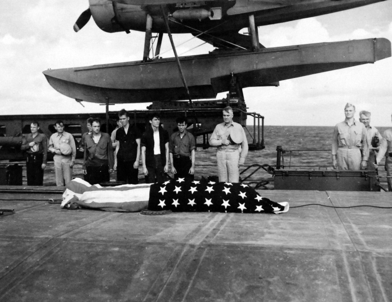80-G-52885:  Battle of Kula Gulf, July 5-6, 1943.   USS Honolulu (CL-48), funeral services onboard for Irvin L. Edwards who died onboard USS Nicholas (DD-449) after being picked up when USS Helena (CL-50) was sunk during the battle.   Admiral Walden L. Ainsworth has hat on his chest.     Official U.S. Navy Photograph, now in the collections of the National Archives.  (2018/04/04).  