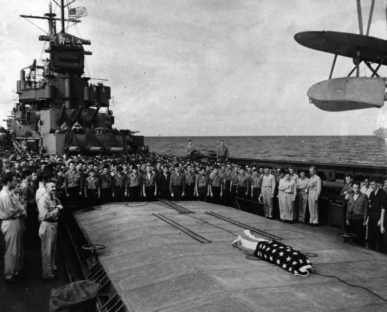 80-G-54558:  Battle of Kula Gulf, July 5-6, 1943.     Funeral service aboard USS Honolulu (CL-48) for Irvin L. Edwards who died aboard USS Nicholas (DD-449) after being picked up when USS Helena (CL-50) was sunk July 6, 1943.   Note Rear Admiral Walden L. Ainsworth, left.     Photograph, July 1943.   Official U.S. Navy photograph, now in the collections of the National Archives.   (2016/07/19).