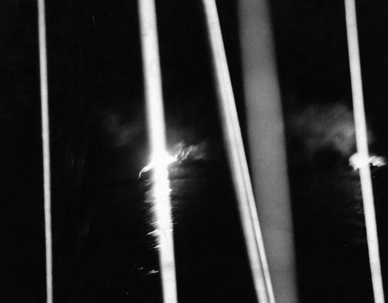 80-G-54560:  Battle of Kula Gulf, July 5-6, 1943.   Note smoke from USS Helena (CL-50), torpedoed and sunk by the Japanese, lighted up by the night firing of other ships.   Photograph, July 1943.   Official U.S. Navy photograph, now in the collections of the National Archives.   (2016/07/19).