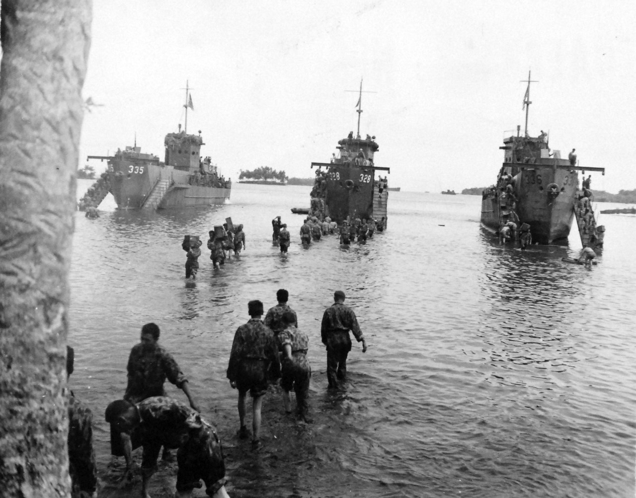 80-G-52623:  Rendova Island Invasion, June 30, 1943.   Troops during the invasion, transporting items from Landing Craft Infantry (Large), LCI(L) 335, LCI(L) 328, and LCI(L) 336.    Official U.S. Navy Photograph, now in the collections of the National Archives.  (2018/04/04).   