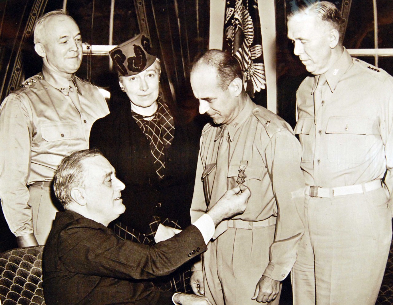 208-PU-52-LL-12: Doolittle Raid on Japan, April 18, 1942.   Brigadier General James H. Doolittle, famous speed flyer who won his wings in World War I, shown receiving the Medal of Honor from President Franklin D. Roosevelt for leading a squadron of Army bombers in a raid on Tokyo and other Japanese cities.  Looking on (left to right) are Lieutenant General H.H. Arnold, Chief of Army Air Forces, Mrs. Doolittle, and then Chief of Staff, General George C. Marshall.  Office of War Information Photograph, now in the collections of the National Archives.  (2017/05/02).