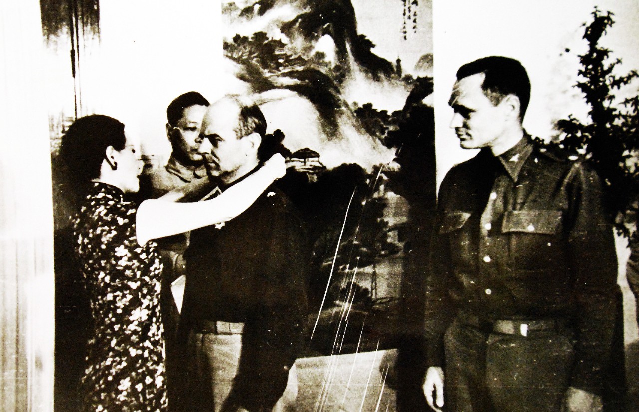 LC-Lot-11629-5: Doolittle Raid on Japan, April 18, 1942.  Madame Chiang Kai-Shek placing the medal of the Military Order of China around the neck of Brigadier General James H. Doolittle, USA.  On the right is Colonel John A. Hilger, USA, who also received the decoration for when U.S. Army forces bombed Tokyo.  Office of War Information Photograph. Courtesy of the Library of Congress.     (2016/01/16).