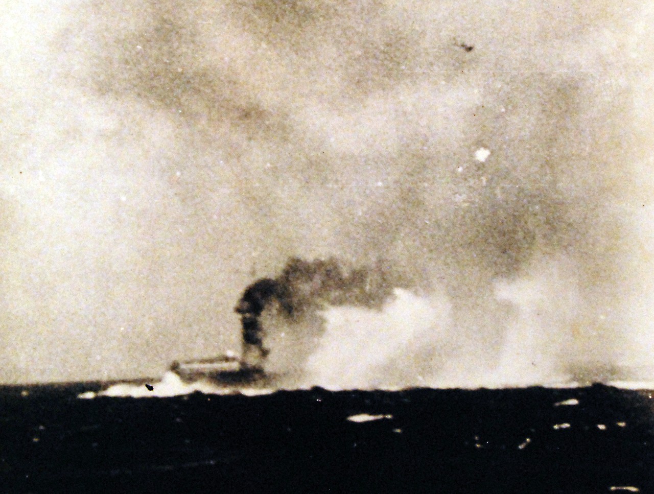 80-G-16653:  Battle of the Coral Sea, May 1942.    n explosion amidships on USS Lexington (CV-2), while she was being abandoned during the afternoon of 8 May 1942. This may be the explosion reported to have taken place at 1727 hrs, which was followed by a "great explosion" aft as stowed torpedo warheads detonated on the hangar deck.   Official U.S. Navy Photograph, now in the collections of the National Archives.    (4/10/2014).